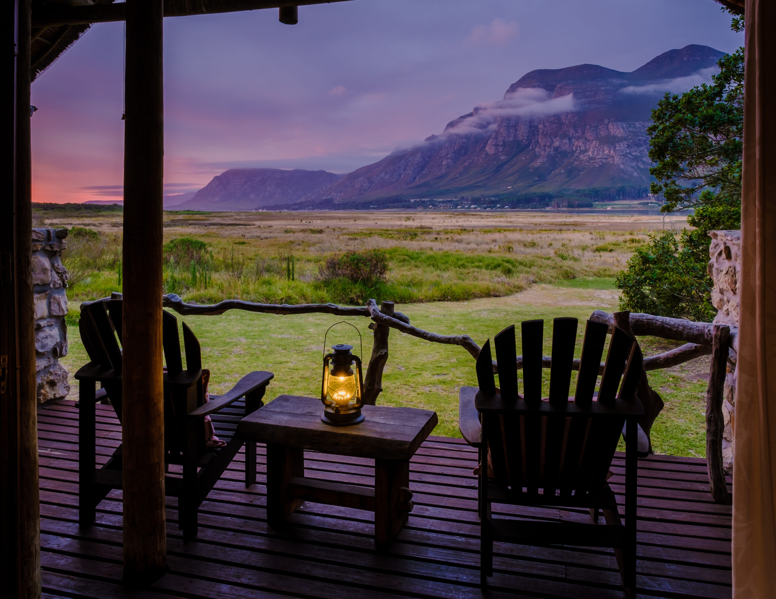 A couple man and woman mid age in front of their lodge during vacation in South Africa Garden Route